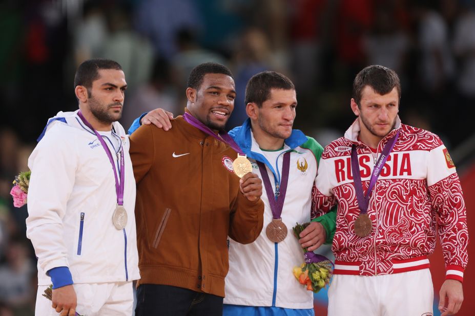 From left to right: Silver medalist Sadegh Saeed Goudarzi of Iran,  gold medalist Jordan Ernest Burroughs of the U.S. and bronze medalists  Soslan Tigiev of Uzbekistan and Denis Tsargush of Russia on the podium of the men's 74-kilogram freestyle.