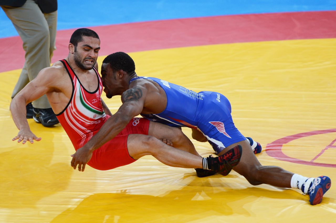 Burroughs, in blue, grapples with Goudarzi in the gold medal match.