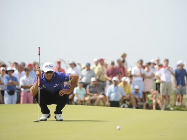 Adam Scott studies the green on the 16th hole.