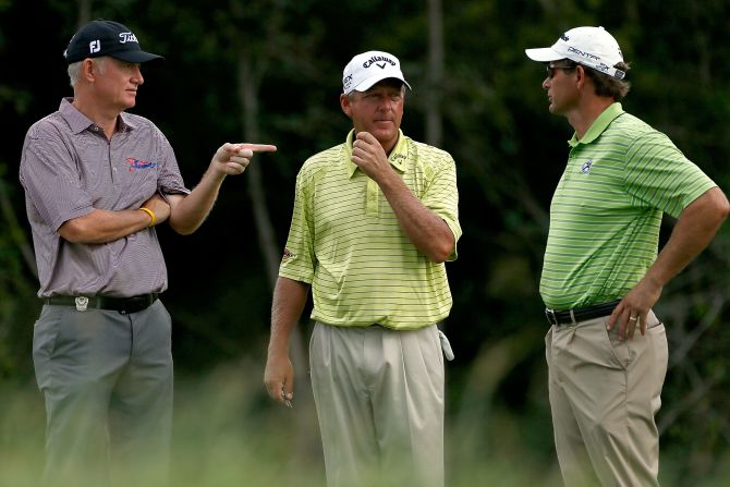 England's Roger Chapman, from left, Mark Brooks of the United States and South Africa's Retief Goosen talk on the 2nd tee.
