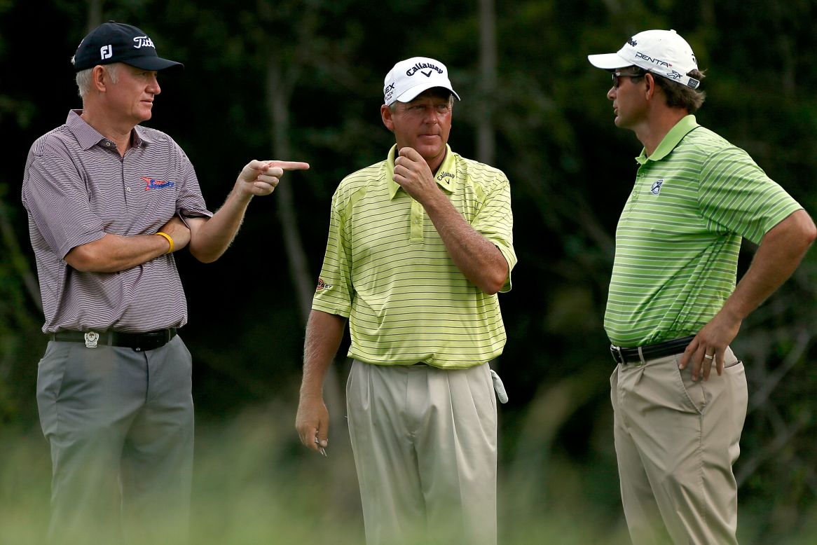 England's Roger Chapman, from left, Mark Brooks of the United States and South Africa's Retief Goosen talk on the 2nd tee.