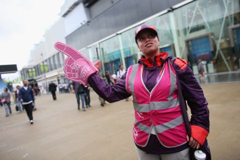 An army of volunteers clad in bright purple, red and pink welcome visitors to the Games.