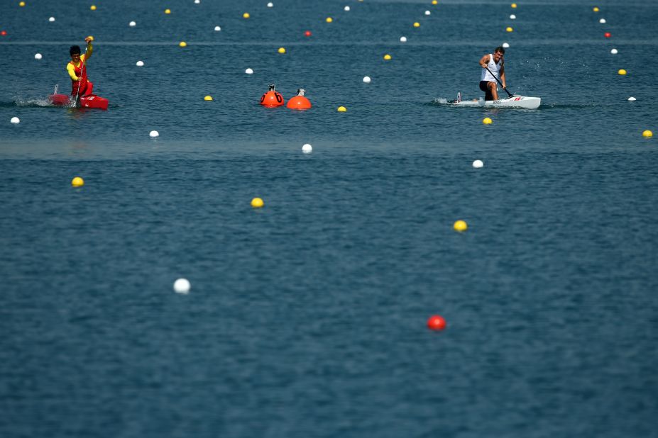 Germany's Sebastian Brendel, right, and Qiang Li of China compete in the men's canoe single 200-meter sprint semifinals.