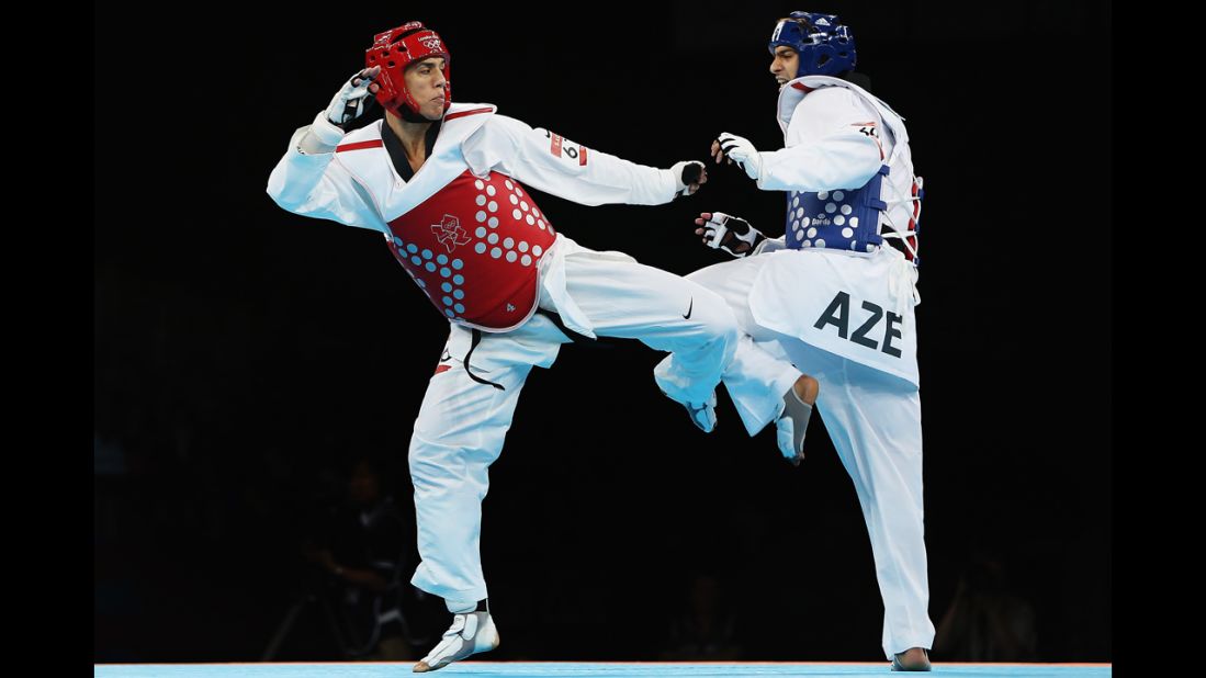 American Steven Lopez, left, competes against Ramin Azizov of Azerbaijan during the men's under 80-kilogram taekwondo preliminary round.