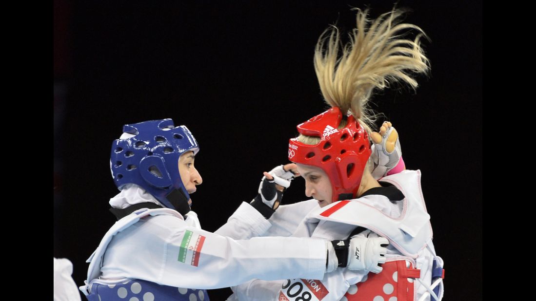 Iran's Sousan Hajipourgoli, left, battles Australia's Carmen Marton in women's taekwondo in the under 67-kilogram division.