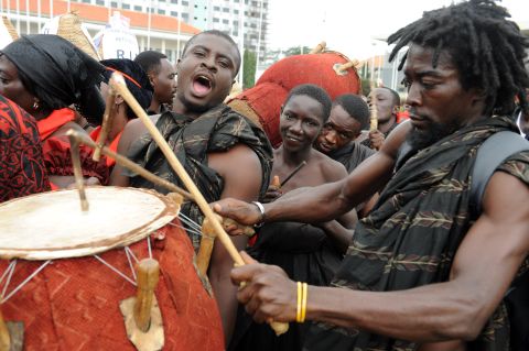 A mourner plays his drum amid a long queue of people gathered Thursday to pay respects to Ghana's late president.