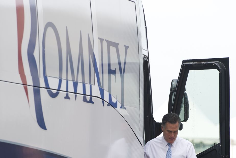 Romney exits his bus at the campaign event.