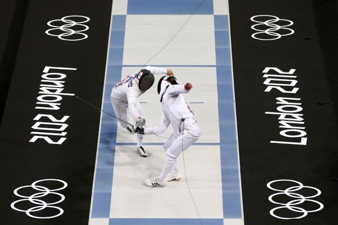 Lithuania's Justinas Kinderis, front, competes against Poland's Szymon Staskiewicz in a fencing bout during the men's modern pentathlon at the London 2012 Olympic Games.
