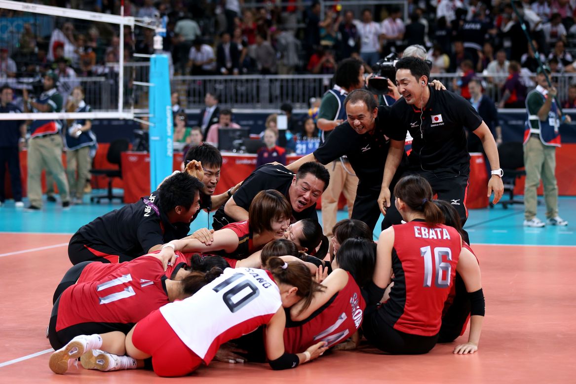 Japanese volleyball players celebrate after their win over South Korea in the women's volleyball bronze medal match.