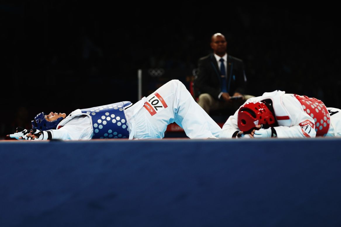 French fighter Anne-Caroline Graffe, right, reacts after her win over South Korean fighter In Jong Lee during the women's taekwondo quarterfinal match.