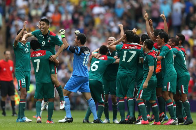 No. 9 Oribe Peralta, who scored both of Mexico's goals, celebrates with his team after defeating Brazil 2-1 in the men's football final.