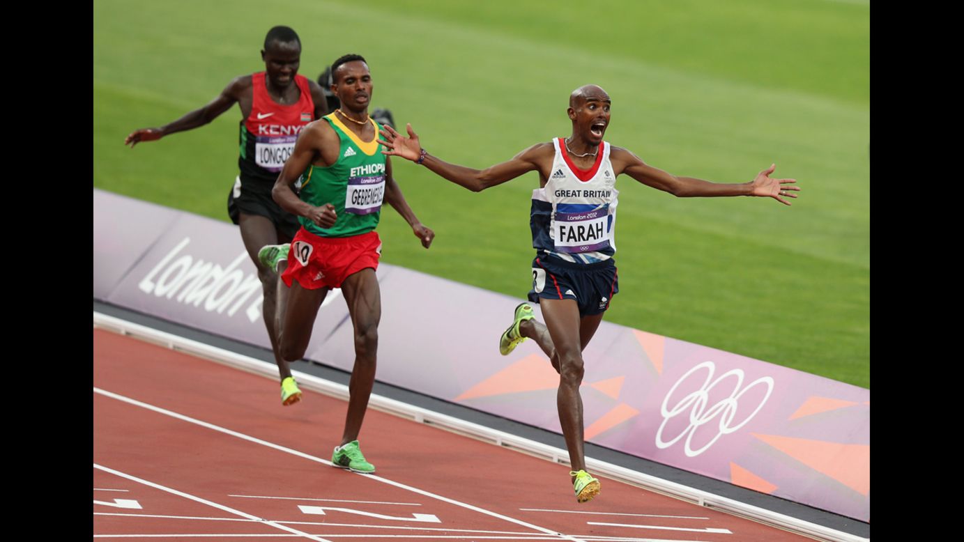 Mohamed Farah, of Great Britain, celebrates as he crosses the finish line to win gold ahead of Ethiopia's Dejen Gebremeskel and Kenya's Thomas Pkemei Longosiwa in the men's 5000-meter final.