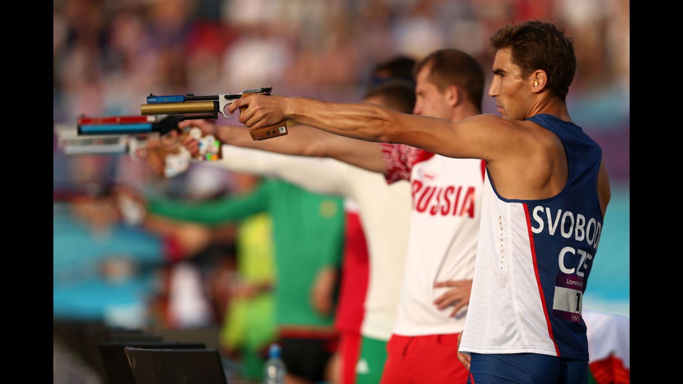 David Svoboda, right, of Czech Republic competes in the combined running and shooting event in the men's modern pentathlon.