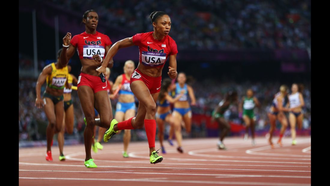 Allyson Felix receives the relay baton from DeeDee Trotter during the women's 4x400-meter relay final. 