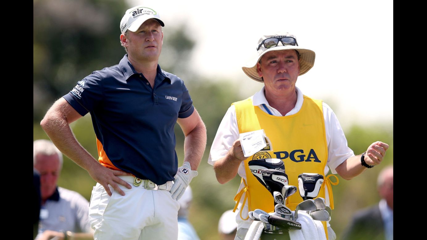 Jamie Donaldson of Wales, left, and his caddie Mick Donaghy look on from the first tee.