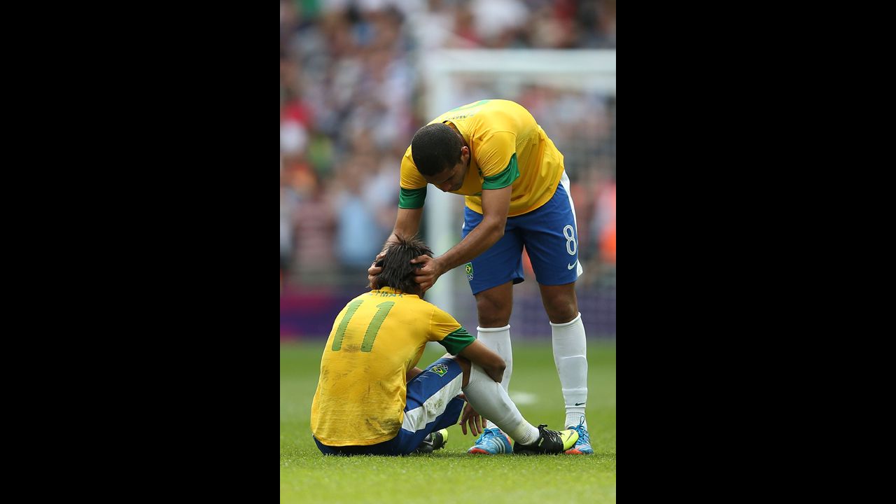 Brazilian soccer player Romulo adjusts a teammate's head with some on-field chiropractic.