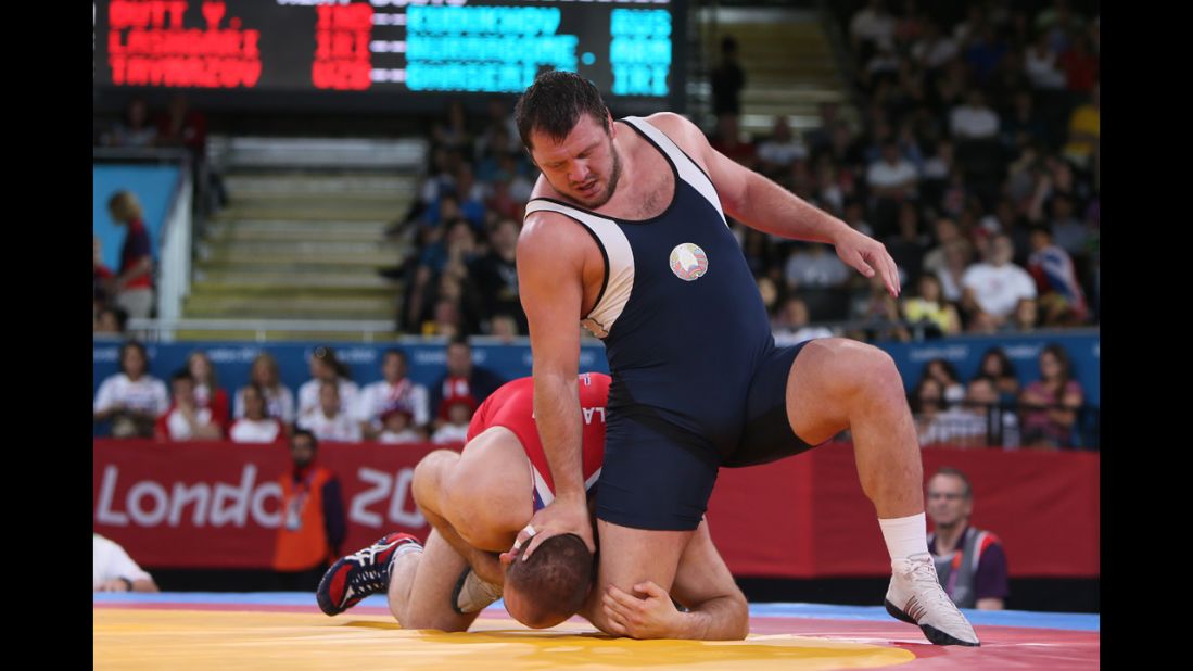 Freestyle wrestling includes butt-kicking, head-banging and -- shown here -- boot-licking.