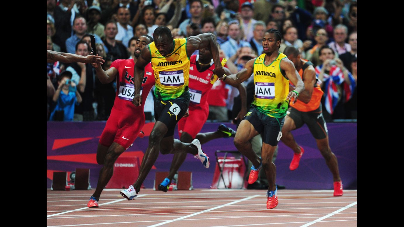 Usain Bolt of Jamaica receives the relay baton from Yohan Blake of Jamaica next to Tyson Gay of the United States during the men's 4x100-meter relay final.