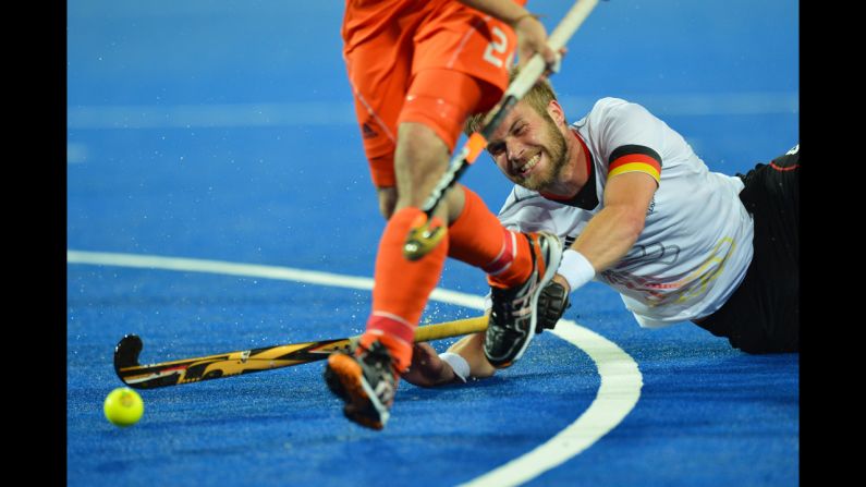 Germany's Maximilian Mueller vies for the ball during the men's field hockey gold medal match between Germany and the Netherlands.