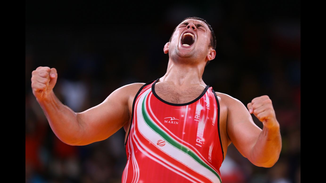Komeil Ghasemi of Iran celebrates winning the bronze medal in the men's 120-kilogram freestyle wrestling.