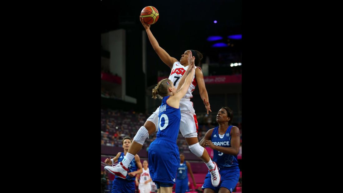 Maya Moore, in white, goes up for a shot against France's Florence Lepron during the gold medal game in London 2012. 