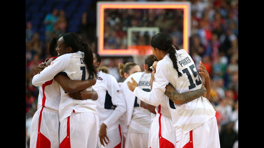 Members of the U.S. women's basketball team hug after defeating France.