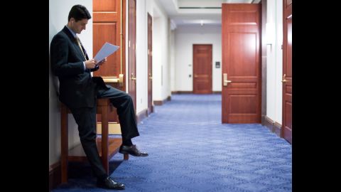 Ryan looks over papers as he waits for other House Republicans to arrive for a news conference in the Capitol Visitors Center in 2010.
