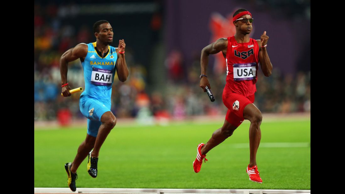 Michael Mathieu of the Bahamas and Tony McQuay of the United States compete in the Men's 4 x 400-meter relay final.