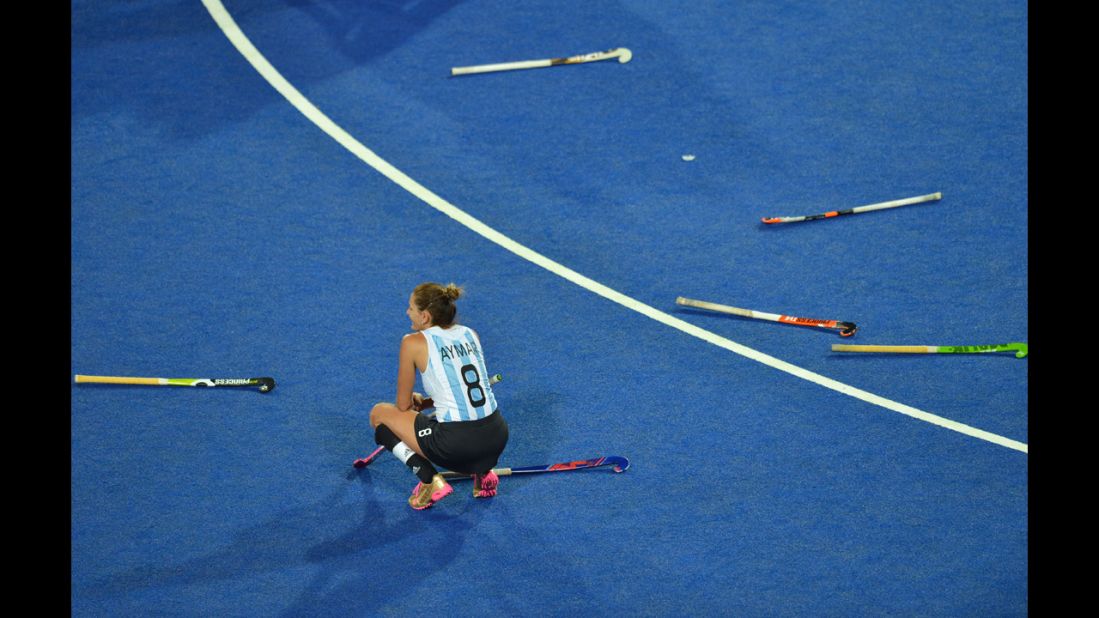 Argentina's Luciana Aymar sits among discarded sticks after her team's defeat in the women's field hockey gold medal match between Netherlands and Argentina.