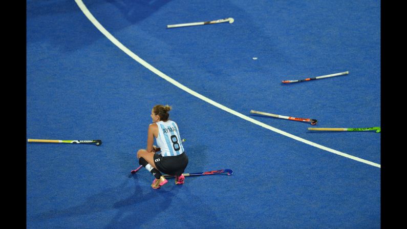 Argentina's Luciana Aymar sits among discarded sticks after her team's defeat in the women's field hockey gold medal match between Netherlands and Argentina.