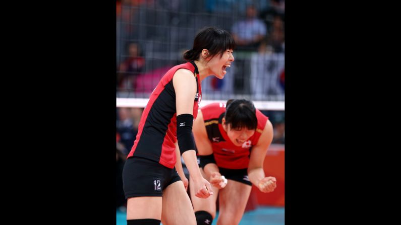 Risa Shinnabe, left, and Erika Araki of Japan celebrate after a point against Korea during the women's volleyball.