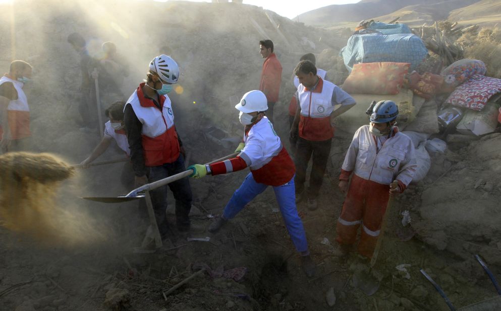Rescue teams search for victims in the rubble of destroyed buildings.