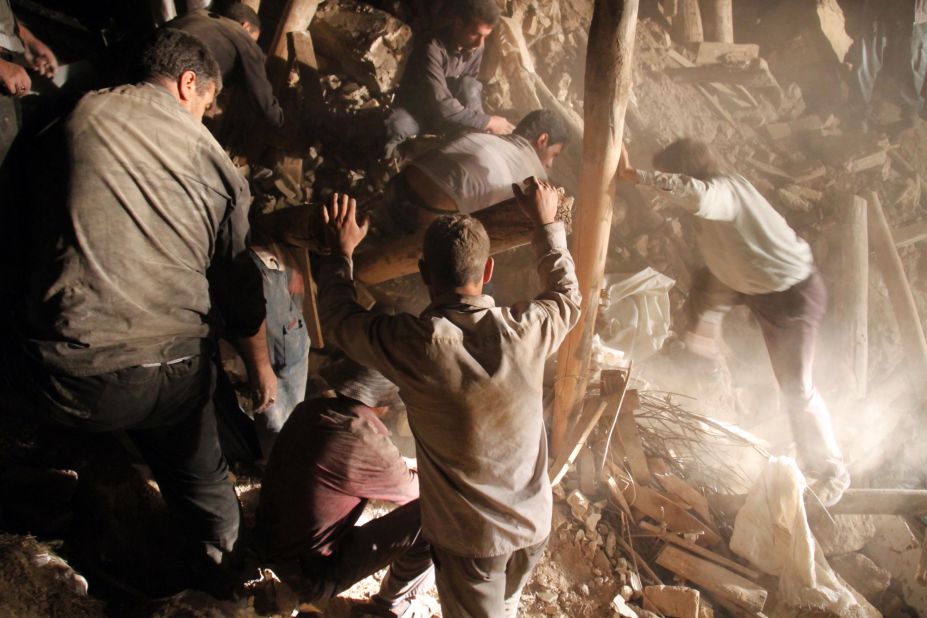 Residents and rescue workers sift through the rubble to find any survivors and recover victims of the earthquakes near the town of Varzaqan.