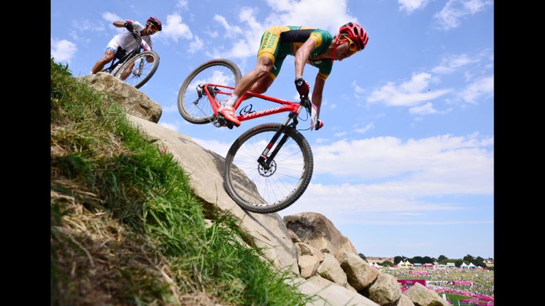 South Africa's Burry Stander, right, and Italy's Marco Aurelio Fontana navigate the course in the men's cross-country mountain bike race at Hadleigh Farm in Benfleet, England.