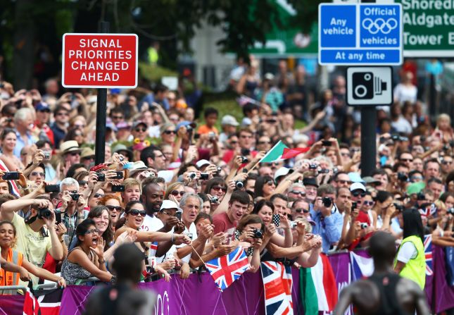 Cheers and an array of cameras greet runners as they wind their way through the streets of London during the men's marathon.