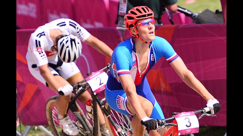 Czech cyclist Jaroslav Kulhavy crosses the finish line ahead of Switzerland's Nino Schurter to win men's cross-country mountain bike race at Hadleigh Farm.