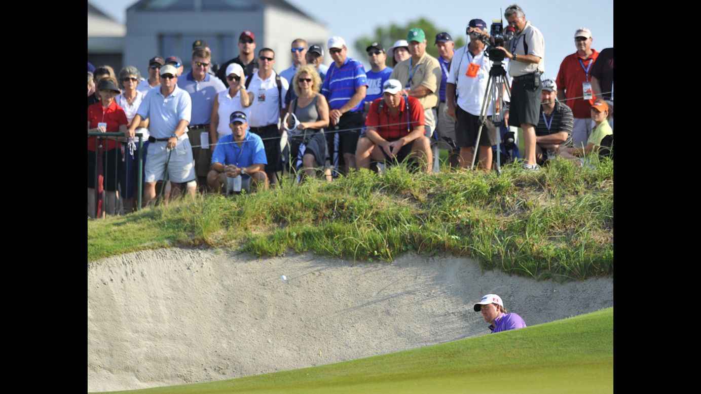 Graeme McDowell blasts out of a sand bunker on Sunday.