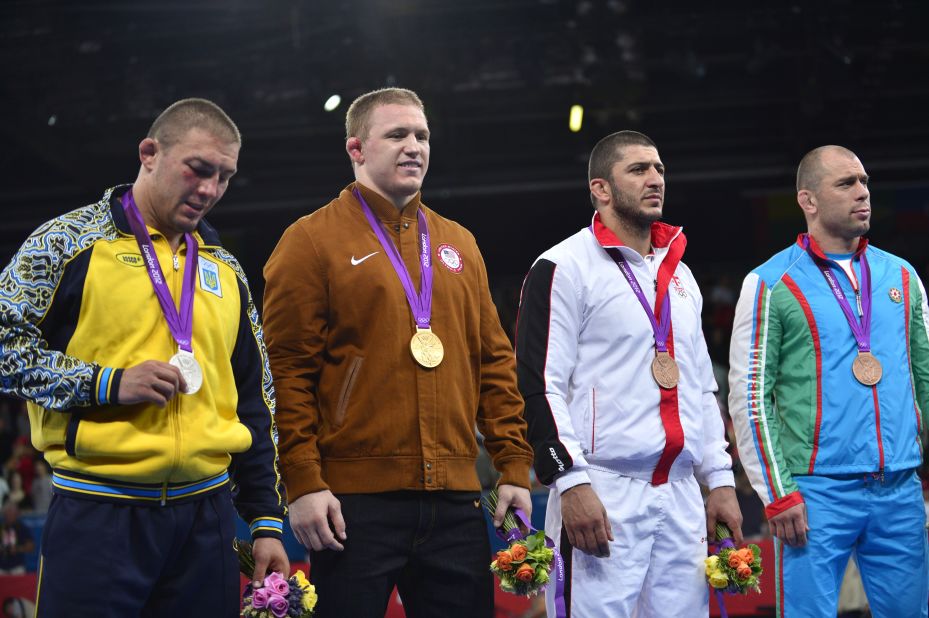 Standing on the podium after receiving their medals are, left to right, silver medalist  Andriitsev, gold medalist  Varner and bronze medalists George Gogshelidze of Georgia and Khetag Gazyumov of Azerbaijan.