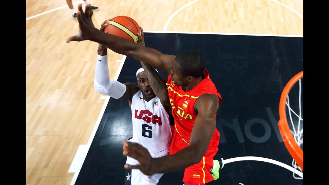 LeBron James goes up for a shot as Serge Ibaka of Spain attempts to block.