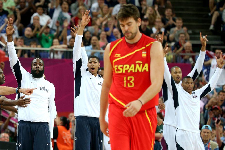 With victory in sight, U.S. players players come off the bench near the game's end as Marc Gasol of Spain walks off.