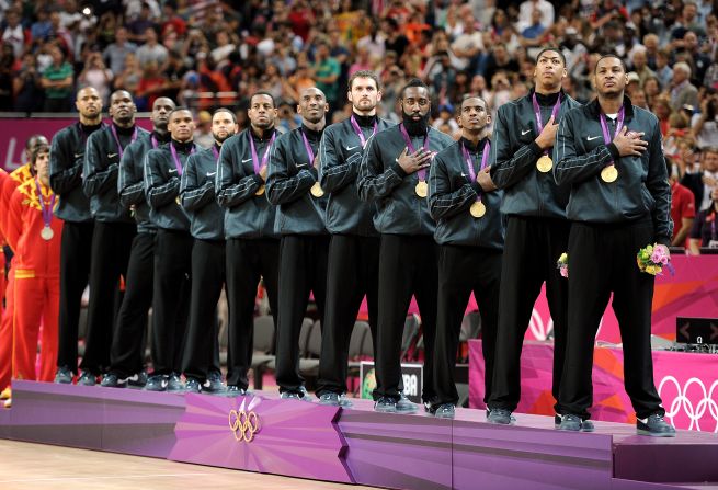 With hands over their hearts, the U.S. team listens as "The Star Spangled Banner" is played after the team was awarded their gold medals.