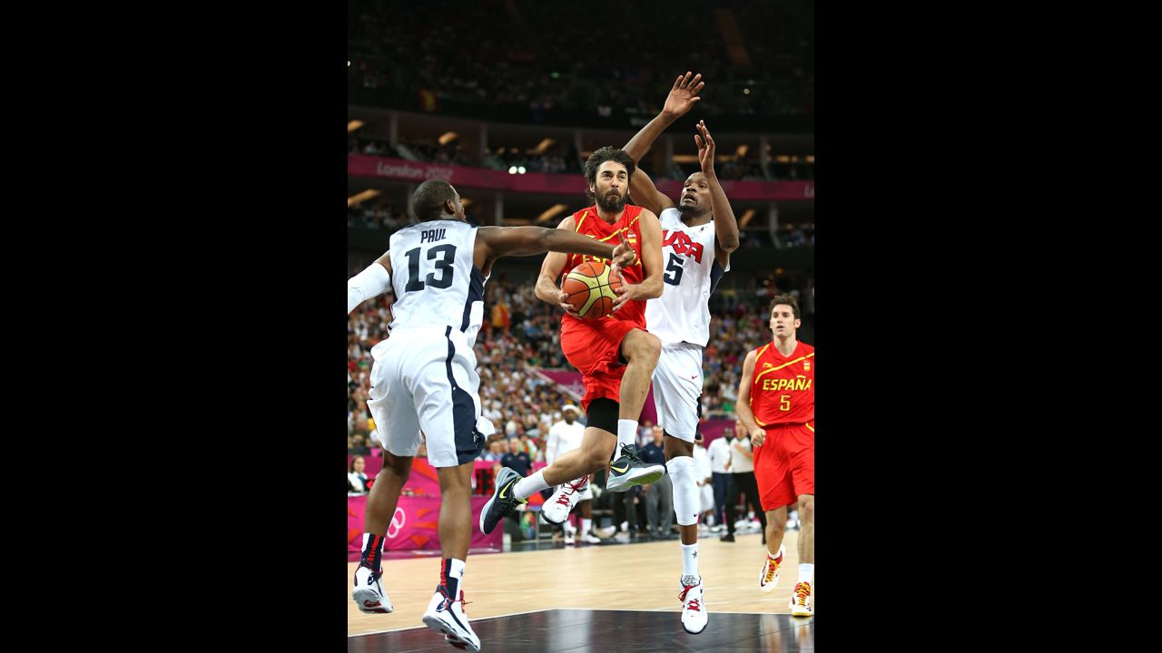 Juan-Carlos Navarro Spain drives to the goal past Kevin Durant and Chris Paul of the United States.