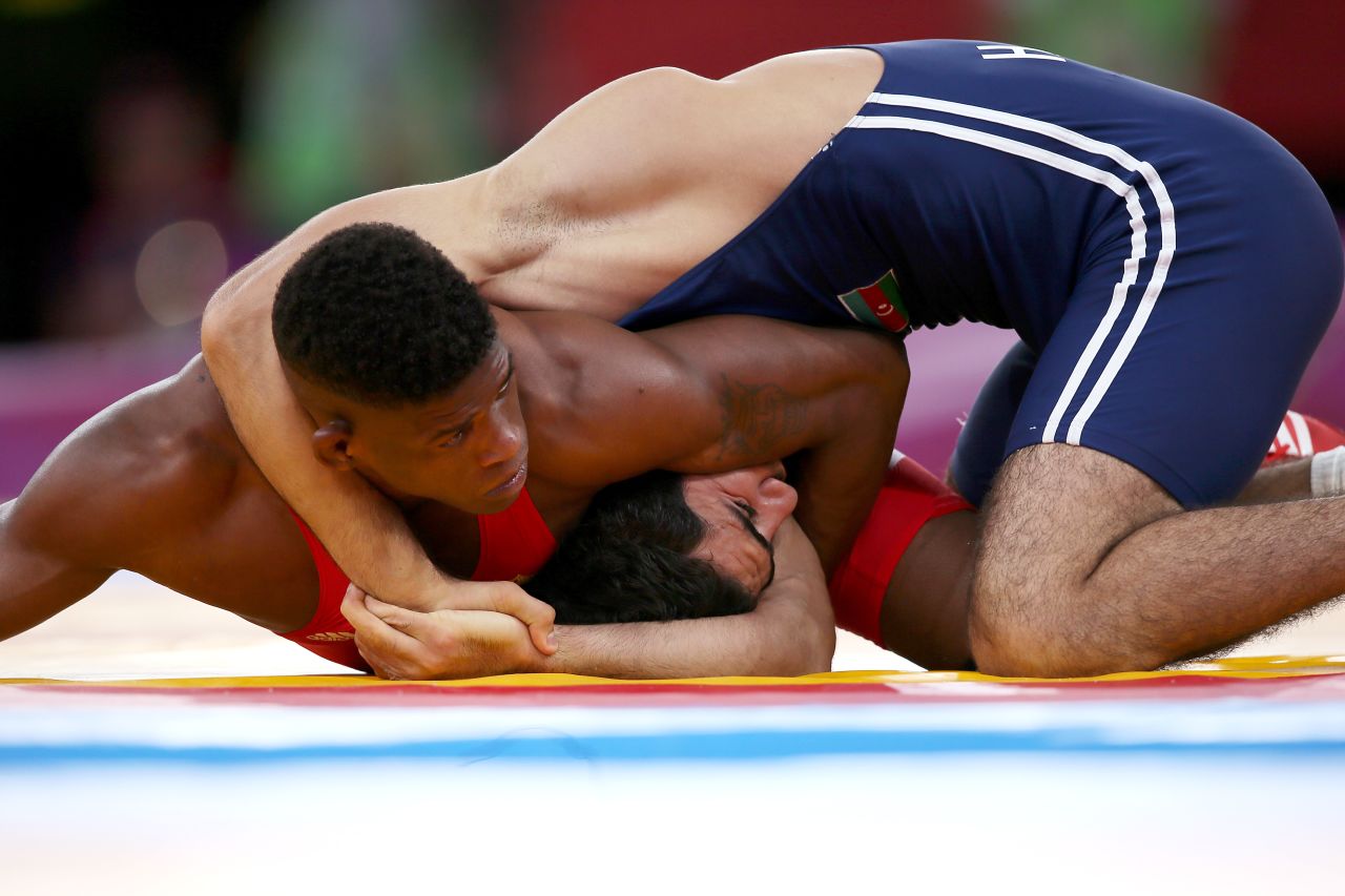 Cuba's Livan Lopez Azcuy, left, wrestles Azerbaijan's Jabrayil Hasanov in their men's 66-kilogram freestyle bronze medal match.