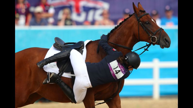 Tamara Vega of Mexico riding Douce de Roulad from her mount in the women's modern pentathlon.