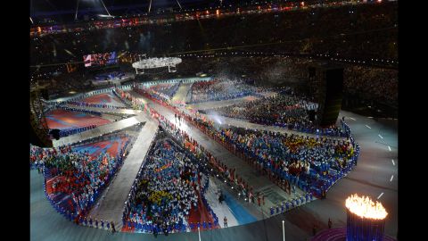 Athletes form a living Union Jack on the floor of Olympic stadium.
