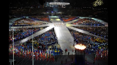Athletes gather in the center of the stadium to form a giant, living rendition of the British Union Jack.