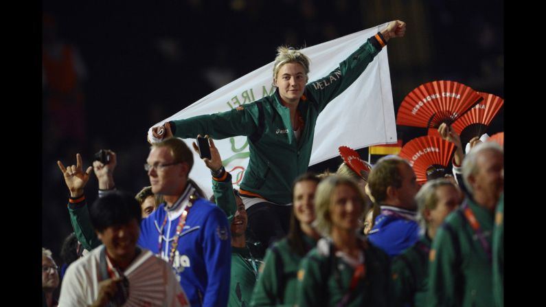 Athletes wave Irish flags at the Olympic stadium.