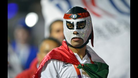 A Mexican athlete wearing a wrestler's mask parades during the closing ceremony.