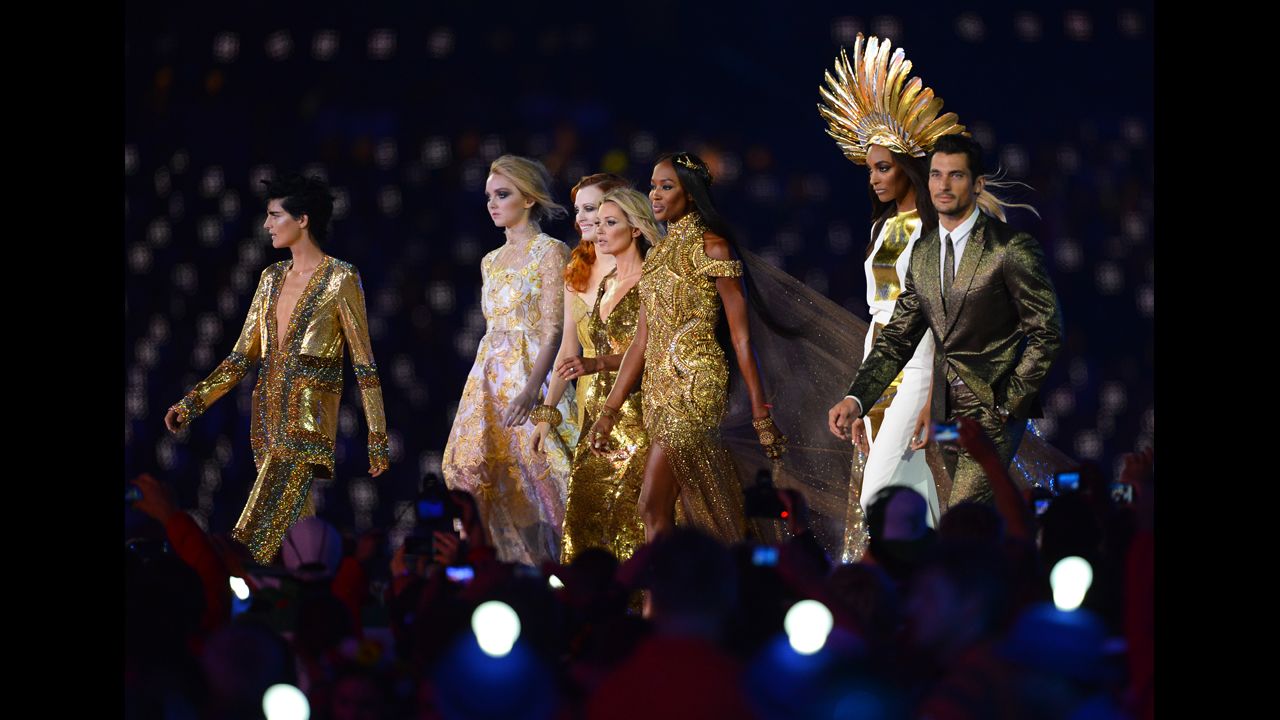 From left, British models Stella Tennant, Lily Cole, Karen Elson,  Kate Moss,  Naomi Campbell,  Jourdan Dunn and David Gandy perform at the Olympic stadium.