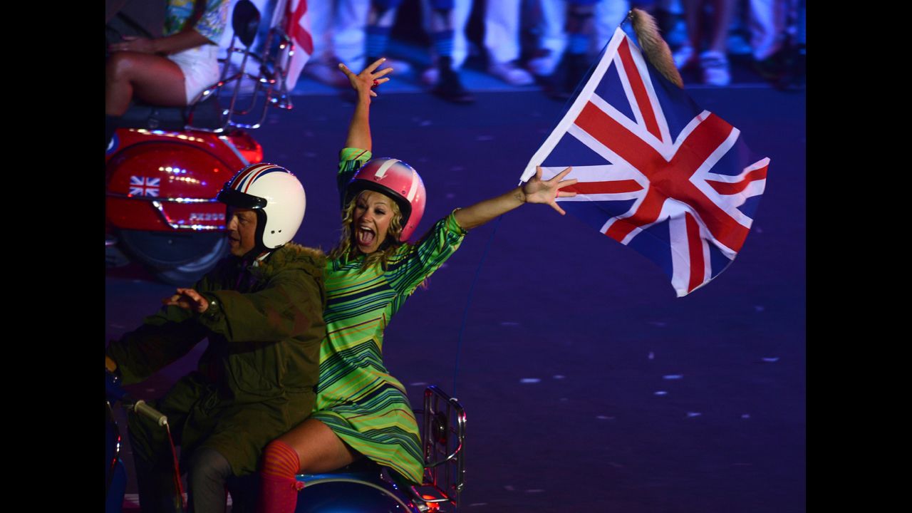 Actors ride scooters during the closing ceremony.